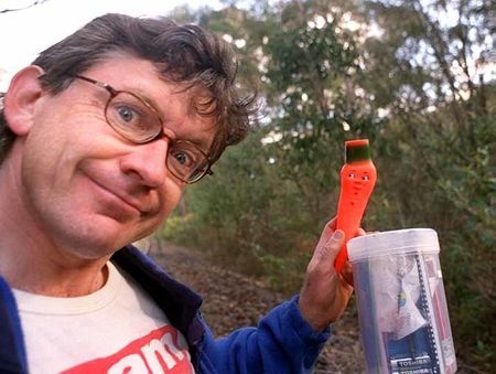 A geocacher smiling after finding a well-hidden cache in Auckland